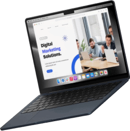 A dark-colored laptop is open, displaying a website about Droved local SEO and AI search optimization agency. The screen shows text and an image of people working together at a table with laptops.