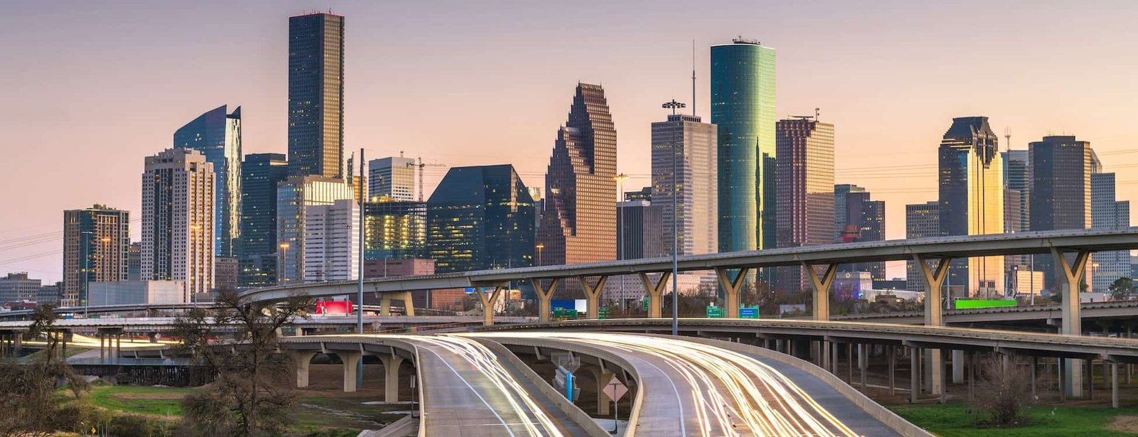 City skyline with skyscrapers and highways at dusk, with Droved’s local SEO and AI search optimization helping service businesses stand out in competitive metropolitan markets on Google Maps and AI platforms.